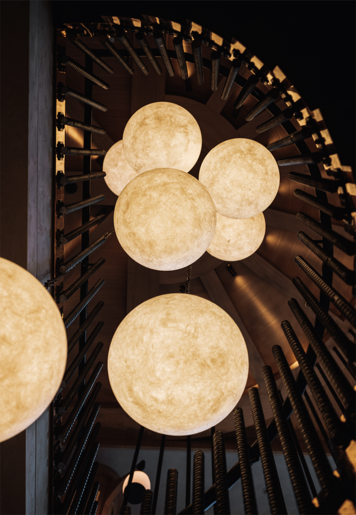 Staircase featuring moon-like chandelier