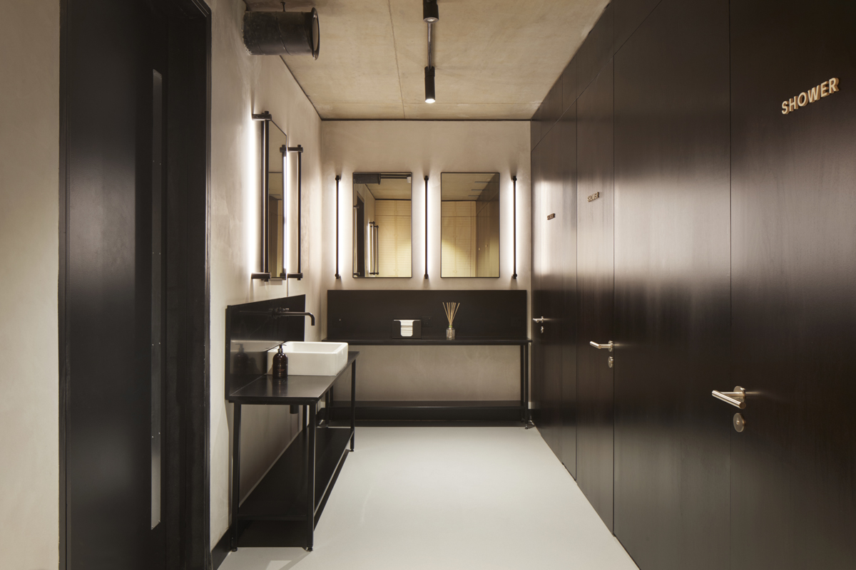 The bathrooms feature black Corian worktops