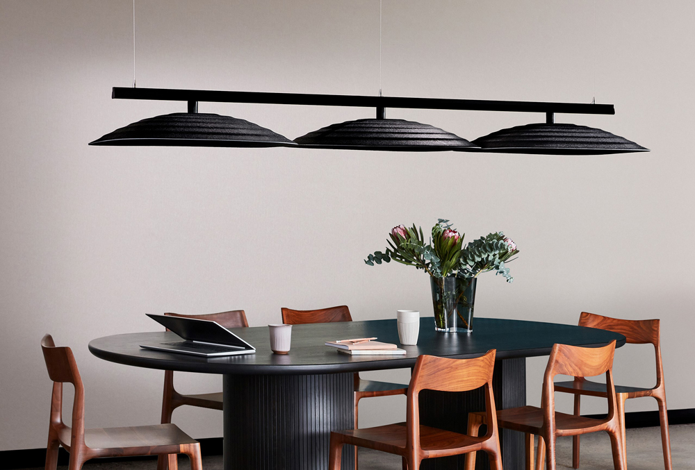 Woven Image's Fuji Ku large 3D acoustic ceiling tiles suspended above a workspace table